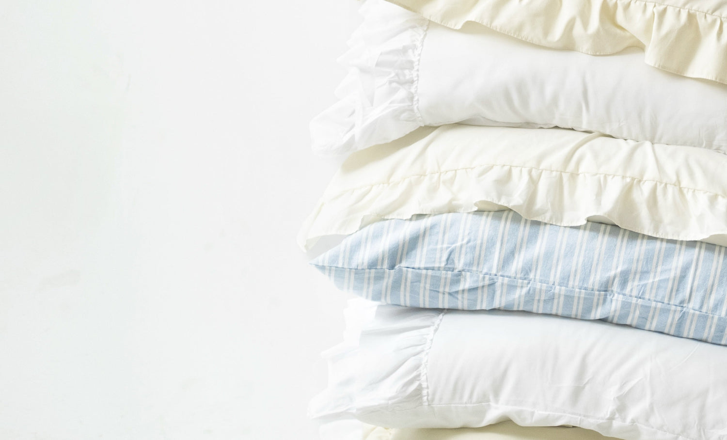 Stack of pillows in various colors on a white background